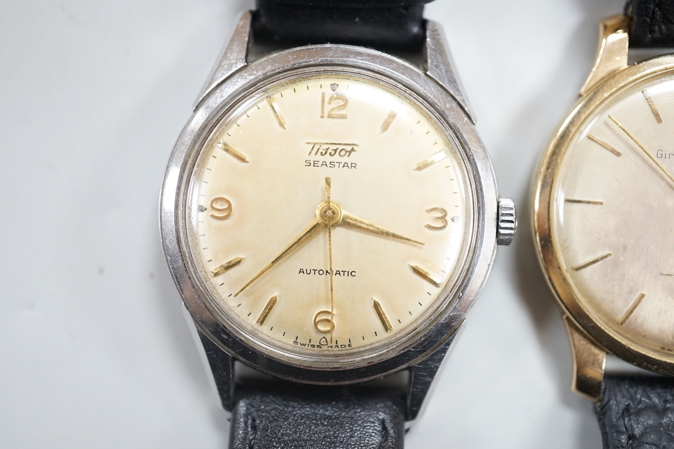 A gentleman's 9ct gold Girard Perregaux manual wind wrist watch, on associated leather strap and a gentleman's stainless steel Tissot Seastar automatic wrist watch.